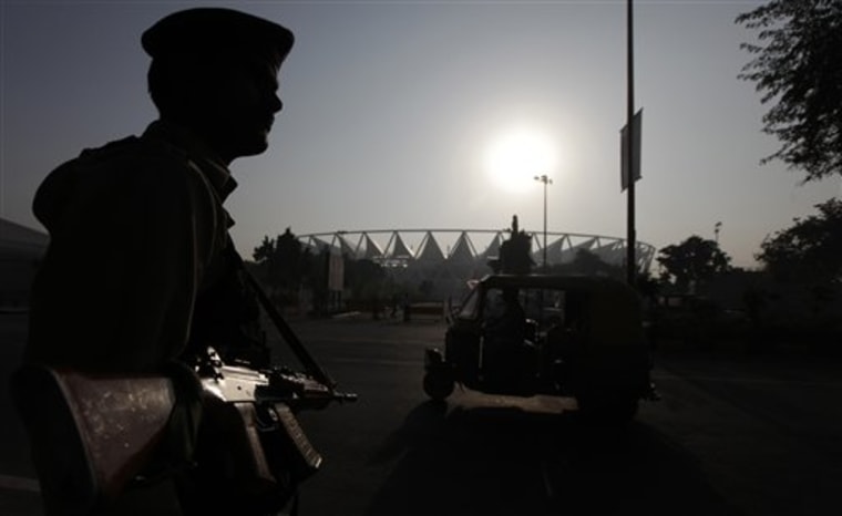 A security guard stands guard outside the Jawaharlal Nehru stadium, the main venue of the Commonwealth Games early in the morning in New Delhi, India, on Sunday.
